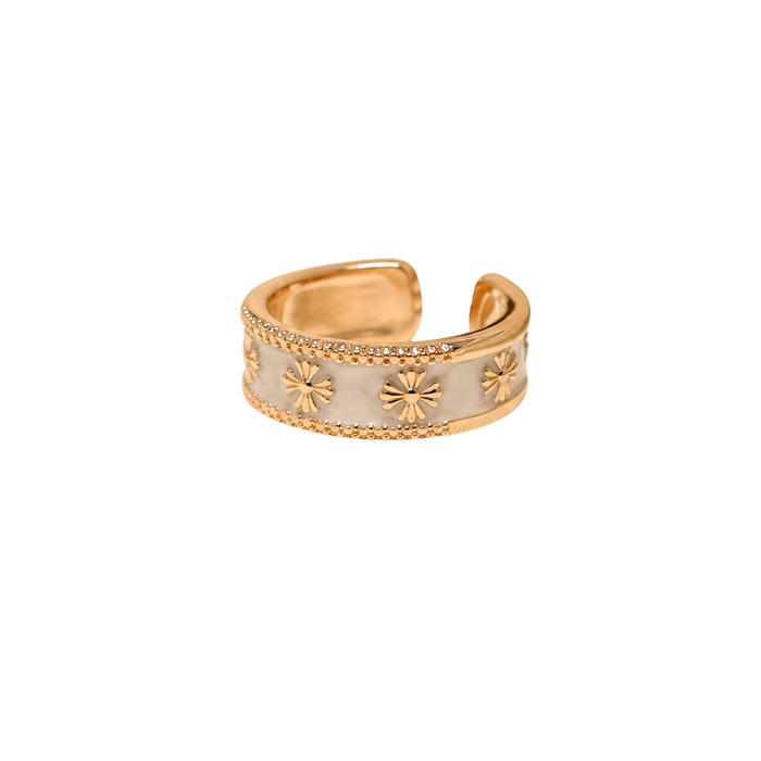A gold-plated adjustable ring with a white enamel center and embossed starburst details, shown on a plain white background.