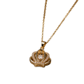 A gold pendant necklace featuring a crown-like design with a central clear gemstone and small pavé-set stones, suspended from a delicate gold chain against a plain white background.