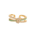 A gold-toned open band ring featuring a central floral cluster of small clear stones and a light green enamel accent stripe, shown on a plain white background.