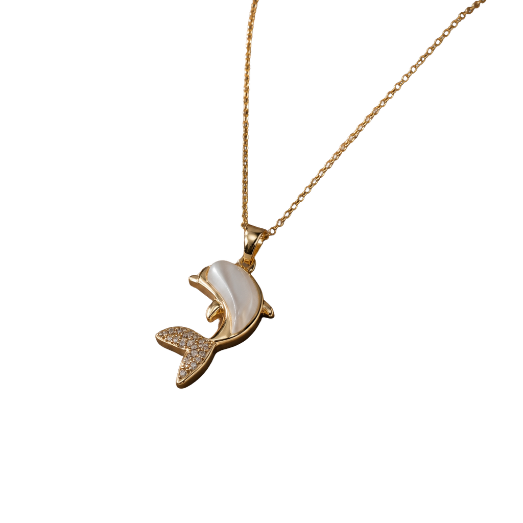 A gold-tone necklace with a dolphin pendant featuring a white mother-of-pearl shell inlay and small clear rhinestone accents on the tail, shown against a plain white background.