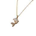 A gold-tone necklace with a dolphin pendant featuring a white mother-of-pearl shell inlay and small clear rhinestone accents on the tail, shown against a plain white background.
