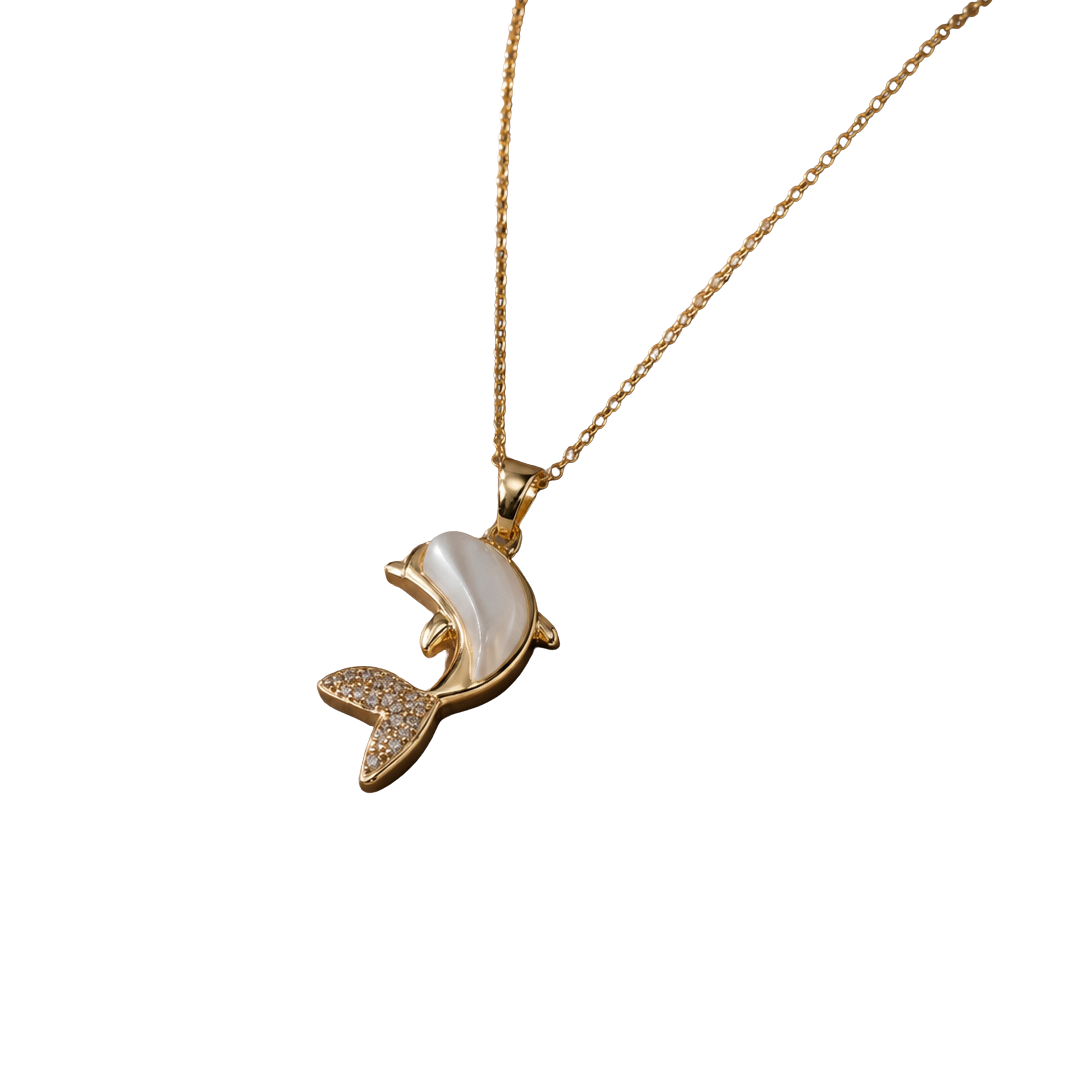 A gold-tone necklace with a dolphin pendant featuring a white mother-of-pearl shell inlay and small clear rhinestone accents on the tail, shown against a plain white background.
