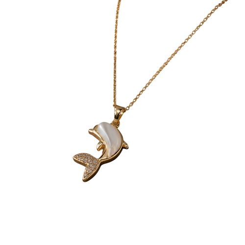 A gold-tone necklace with a dolphin pendant featuring a white mother-of-pearl shell inlay and small clear rhinestone accents on the tail, shown against a plain white background.