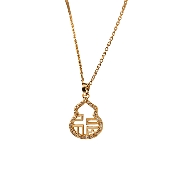 A gold chain necklace with a small, gold pendant featuring a stylized Chinese character for 'fortune' surrounded by tiny clear stones, shown against a plain white background.