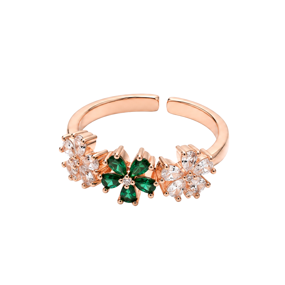 A rose gold adjustable ring featuring a central green four-petal flower motif flanked by small clear crystal clusters, shown on a plain white background.