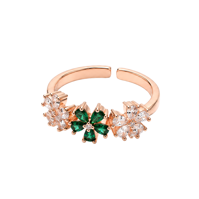 A rose gold adjustable ring featuring a central green four-petal flower motif flanked by small clear crystal clusters, shown on a plain white background.